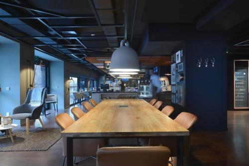 a conference room with a wooden table and chairs at Courtyard by Marriott Brussels EU in Brussels
