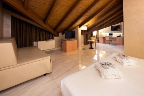 a bedroom with two beds and a living room at Best Western Modena District in Campogalliano