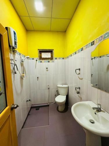 a bathroom with a toilet and a sink at LOTUS HOLIDAY REST in Anuradhapura