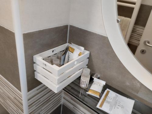 a bathroom vanity with a white box on a table at B&B Il vicoletto in Pratola Peligna