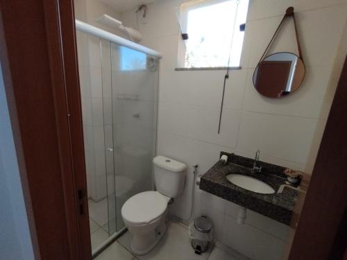 a bathroom with a toilet and a sink and a shower at Aconchego da Jandaia in Imbassai