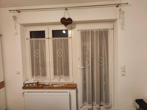 a room with a window with curtains and a radiator at Else' s Stübchen in Welling