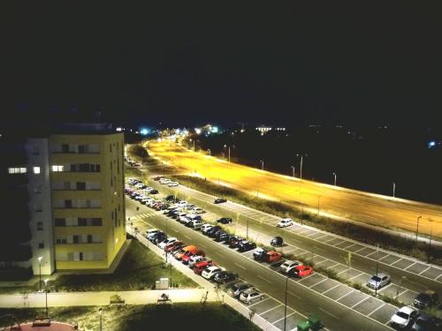 a parking lot filled with cars at night at Penthouse Danube Exclusive, Parking, 90m2, Wifi in Novi Grad