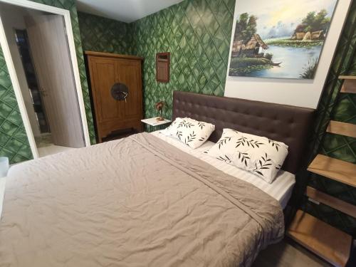 a bedroom with a bed and a painting on the wall at The Marvest Hua Hin in Hua Hin