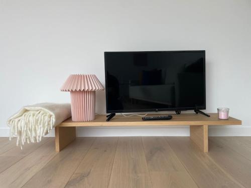 a flat screen tv sitting on a wooden table at #2800ourhome 301 in Mechelen