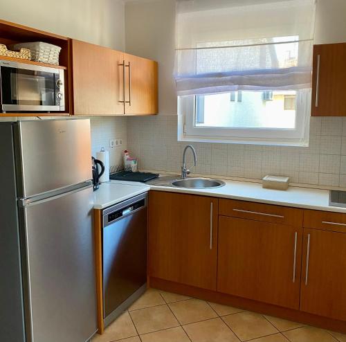 a kitchen with a stainless steel refrigerator and a sink at Lake Apartment in Hévíz