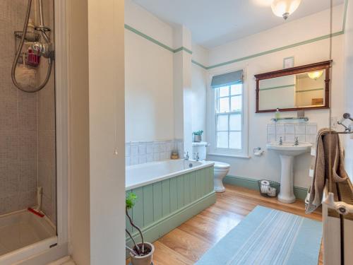 a bathroom with a tub and a sink at Pass the Keys Cosy 2 Bed Cottage With Views of The Iron Bridge in Ironbridge