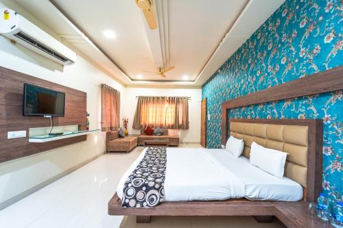 a bedroom with a bed and a tv on a wall at Hotel Royal Palace in Sāgar