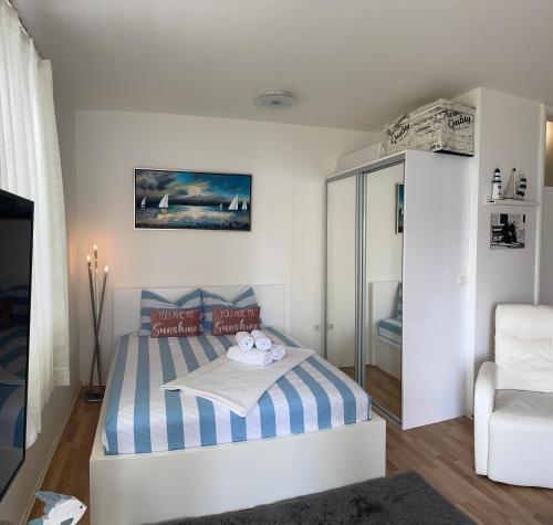 a small bedroom with a bed and a chair at Studio Apartment Pag Luxury 4U in Pag