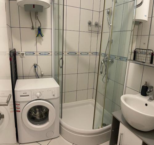 a small bathroom with a washing machine and a sink at Studio Apartment Pag Luxury 4U in Pag