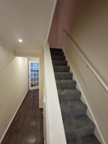 a stairway in a home with a stair case at Kenilworth Gardens in Kent