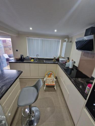 a small kitchen with a chair and a sink at Kenilworth Gardens in Kent