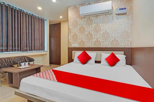a bedroom with a large bed with red pillows at Flagship The Leggend Inn Hotel in Patna