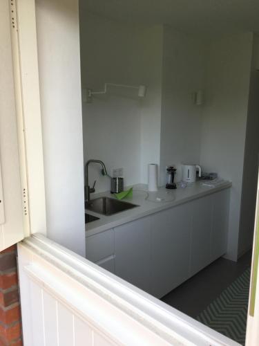 a kitchen with a sink and a counter top at Nije Haven Bed & Breakfast in Wrixum