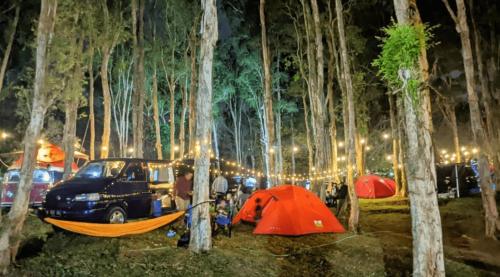 a group of tents in a forest at night at glamping camping kamping in Ungasan