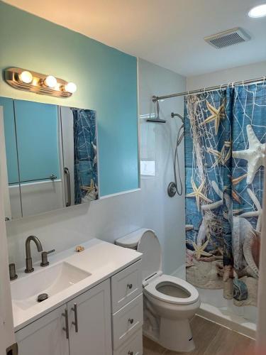 a bathroom with a toilet and a sink and a shower at Seashell 8 - Seasonal Rental in Boynton Beach