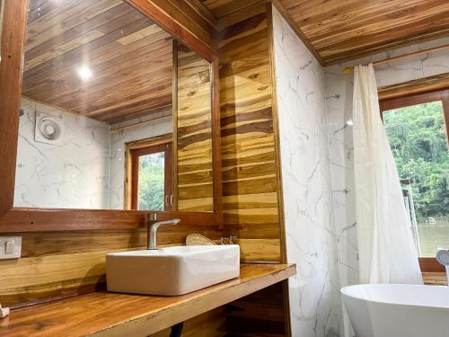 a bathroom with a sink and a mirror at Nongkhiaw The Float House in Nongkhiaw