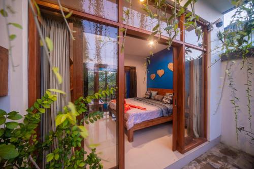 a bedroom in a house with a bed in it at Cheerful Private 1Br HoneyMoon Villa BlueLove Seririt in Banjar