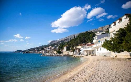 a view of a beach with buildings and the water at Beach pearl 1 in Jesenice