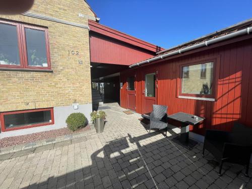eine Terrasse mit einem Tisch und Stühlen neben einem Gebäude in der Unterkunft Bak Guesthouse in Kopenhagen