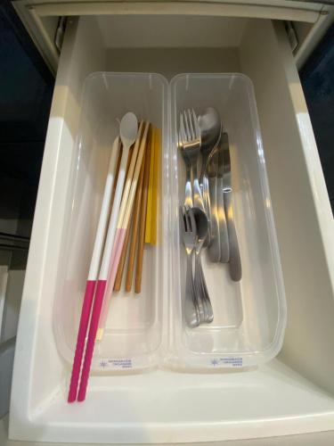 a plastic container with utensils in a drawer at Nakajima Park stay AMS tower Nakajima 16F in Sapporo