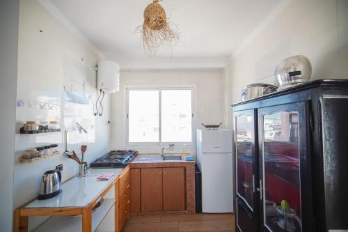 a kitchen with a black and white refrigerator at Sand House in Imsouane