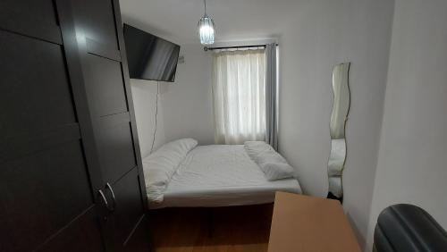 a small room with a bed and a window at Love & Travel in Dublin