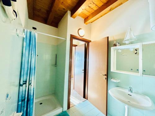 uma casa de banho com um chuveiro, um lavatório e um WC. em Rea Apartment - 500 m dal Lago con Piscina em Sirmione