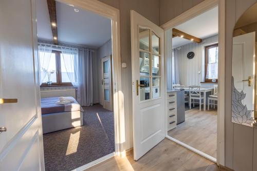 a bedroom with a bed and a mirror at Apartament u Majerczyka in Zakopane