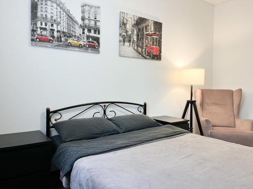 a bedroom with a bed and a chair at 054 квартира ЖК Софія Резиденс, 1 поверх in Kyiv