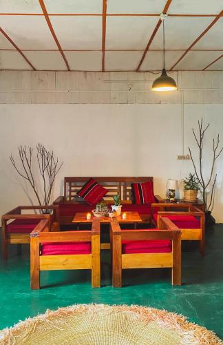 a living room with wooden tables and couches at Chengjel Home- come to life in Ukhrul