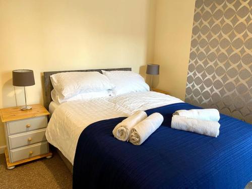 a bedroom with a bed with towels on it at Eden Stay 5 Bedroom House in Morecambe