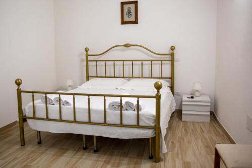 a bedroom with a large bed with white sheets at Da Zia Maria in Ferrandina