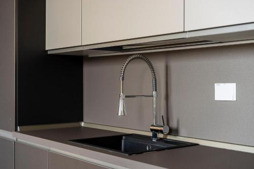 a kitchen with a sink with a faucet at San Marco Black Appartamento Luxury con Terrazzo e Parcheggio su richiesta in Florence