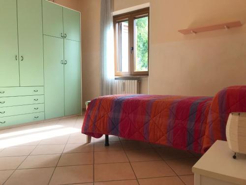 a bedroom with a bed and a dresser and a window at Villa Enrico in Monticchio