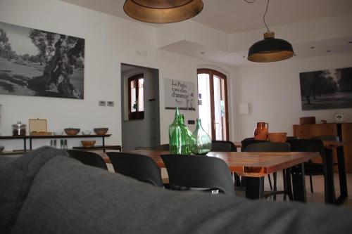 a dining room with a table and chairs and bottles at B&B Le Terrazze Lama Balice in Bitonto