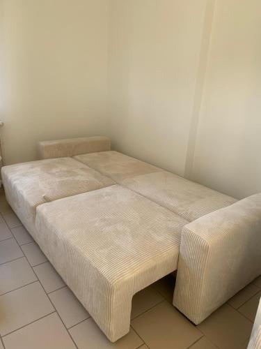 a bed sitting in a room with at Appartement T2 cosy in Gourdon-en-quercy