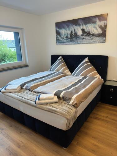 a large bed in a room with a window at Villa Hilden in Hilden