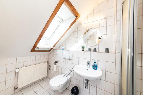 a bathroom with a sink and a skylight at Pension am Sandberg in Leipzig