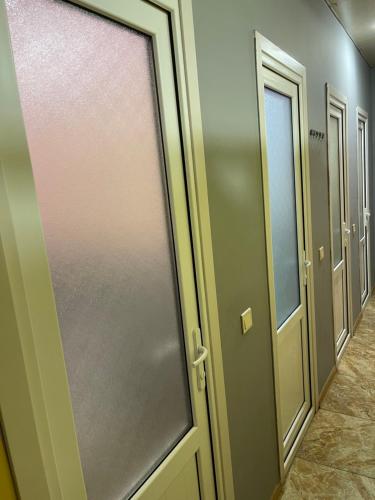 a row of doors in a hallway with a window at CITRUS Guest House in Yerevan