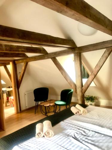 a bedroom with a bed and two chairs in it at U Zeleného jalovce in Prague