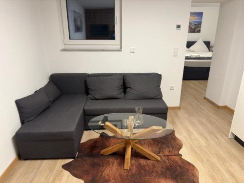 a living room with a couch and a glass table at Villa Hilden in Hilden