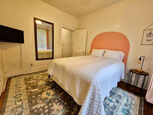 a bedroom with a large bed and a television at Cool and calm place to live in Memphis