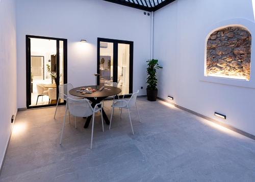 a dining room with a table and chairs at Maison 36 Villa in the center of Psyri in Athens