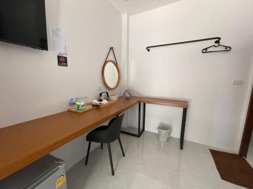 a room with a desk with a mirror and a chair at PP. Valentine Bungalow in Phi Phi Don