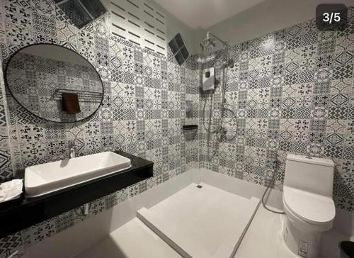 a bathroom with a sink and a toilet and a mirror at PP. Valentine Bungalow in Phi Phi Islands