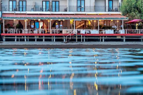 a restaurant next to a body of water at Sappho Hotel in Skala Eresou