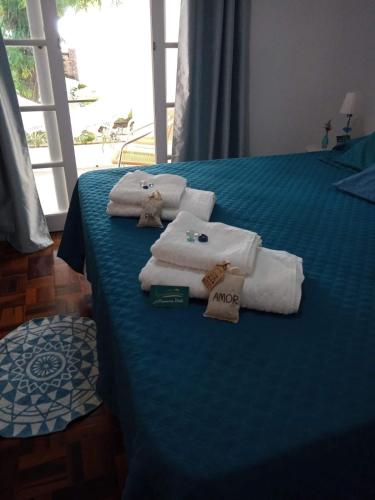 a room with a bed with towels on it at A Primeira Vista in Florianópolis