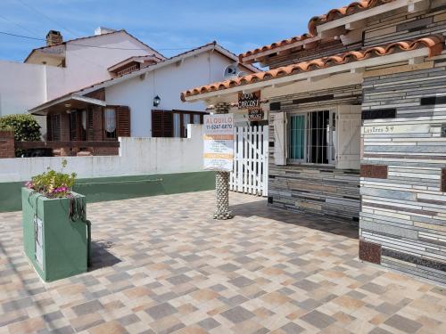 a house with a sign in front of it at Junto Al Mar Y Centro De Santa Clara, Dos Casas in Santa Clara del Mar