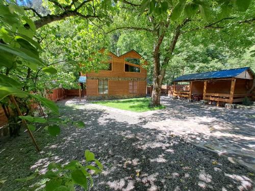 a house with a tree and a building at Villa Maxi Likani in Likani